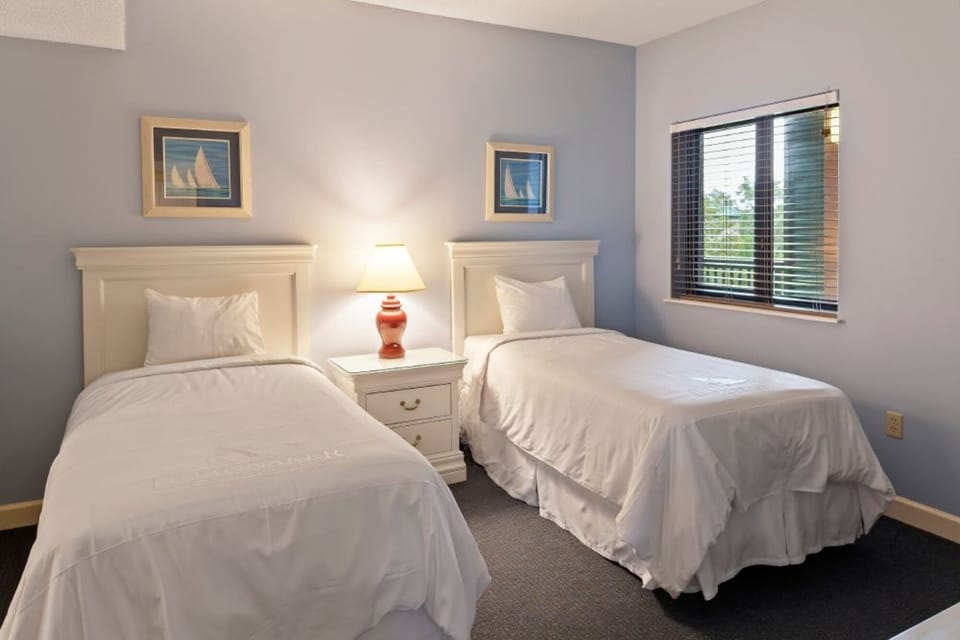 Wake refreshed in tidy twin beds with coastal-inspired decor.