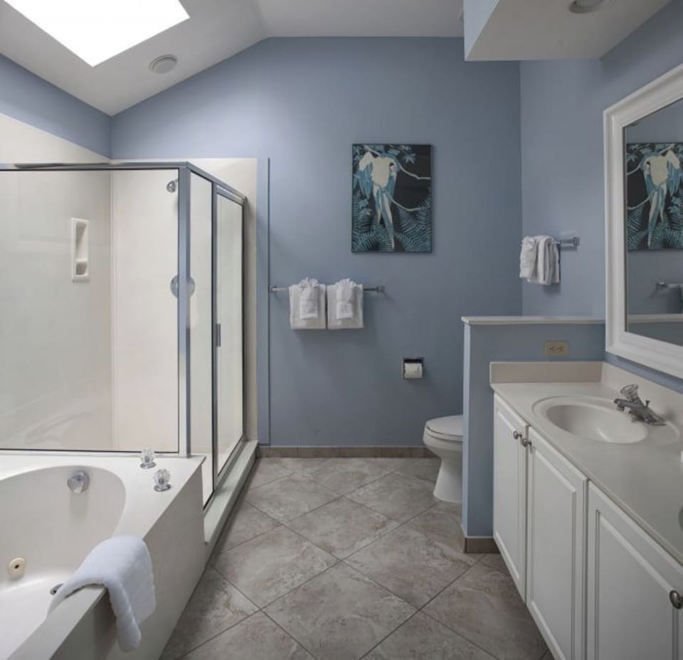 Refresh in a spa-like bath with tub and glass shower.
