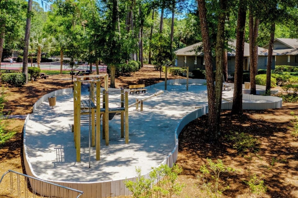 Let kids play freely in the shaded, sandy playground area.