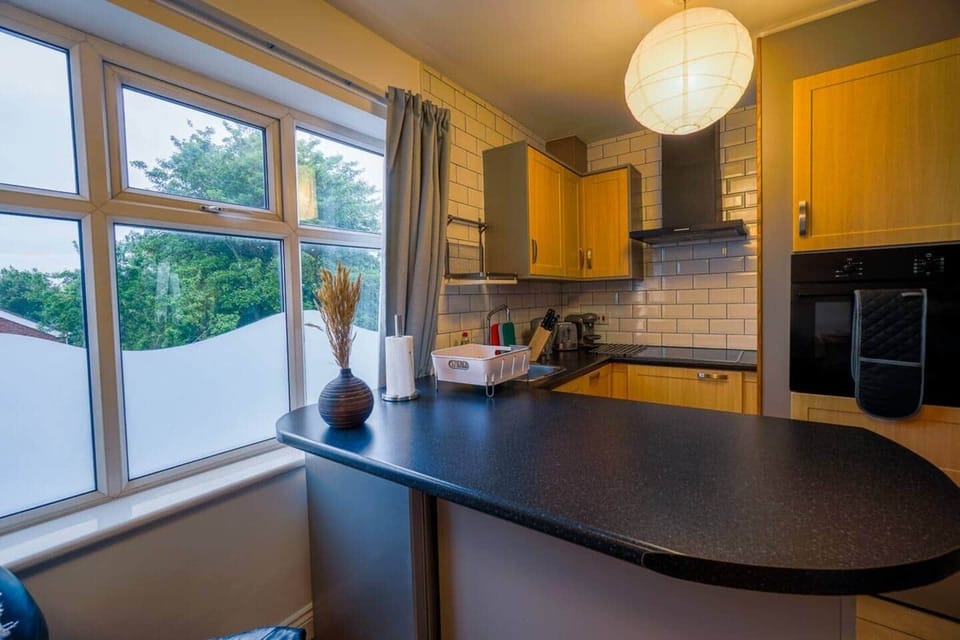 View of Leeds skyline visible whilst you cook in this well equipped and well designed workspace.
Full exterior venting extractor reduces cooking smells.
Microwave is hidden away in one of the many useful cupboards
Linked smoke detectors. Safety first