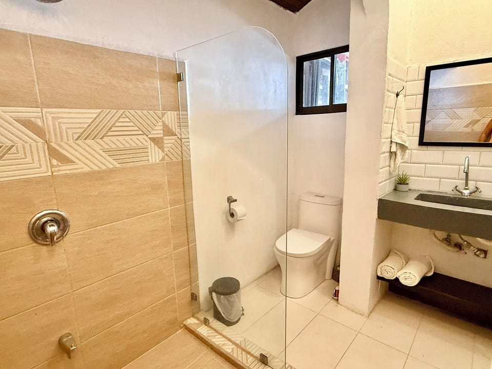 Queen Bed, Patio and Garden View | Bathroom | Shower, free toiletries, hair dryer, towels