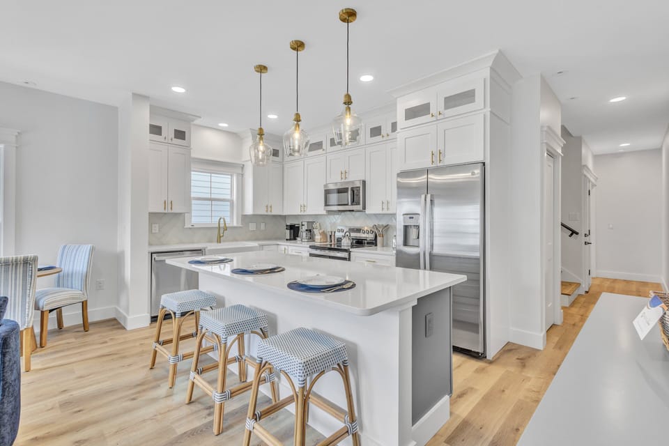 HOST & HOME presents…200 Olive Shell Court! Located in the luxurious community of The Homes at Olive Shell, this three-story townhome features high-end finishes, 9-foot ceilings, has 4 bedrooms, and a spacious garage.