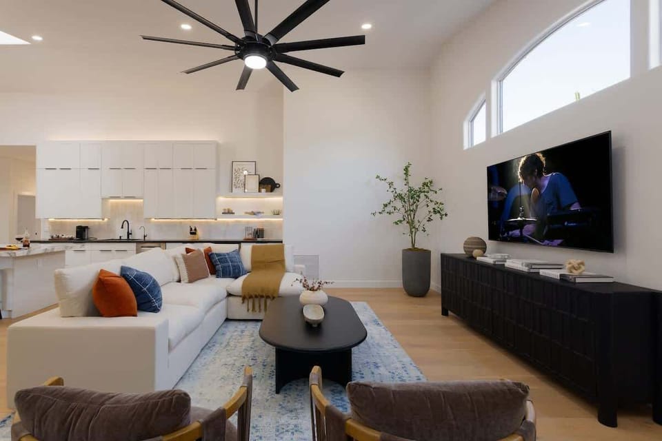Main living area featuring designer furnishings, a Smart TV, and a fireplace.