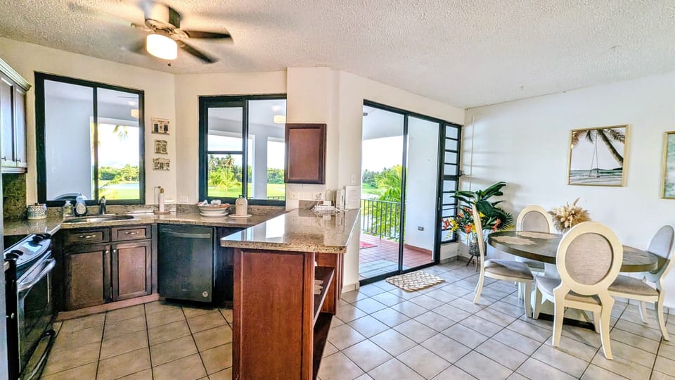 Bright kitchen and dining area with golf course views 