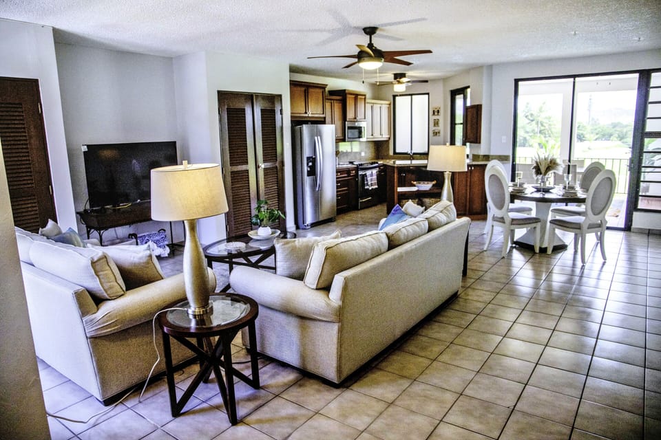 Spacious living room with open layout, natural light, and cozy seating.