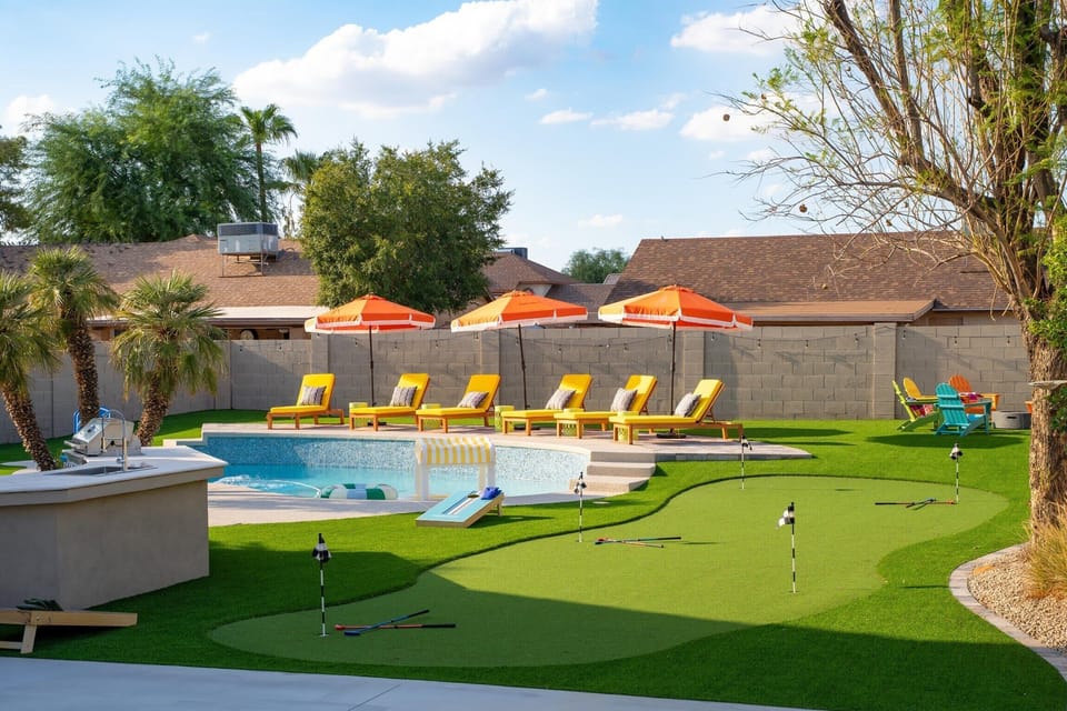 Get ready for endless fun in the sun right in your own backyard! Dive into the sparkling pool, then challenge your crew to a friendly game on the putting green. With comfy loungers and vibrant umbrellas, this is ultimate spot for relaxation and play!
