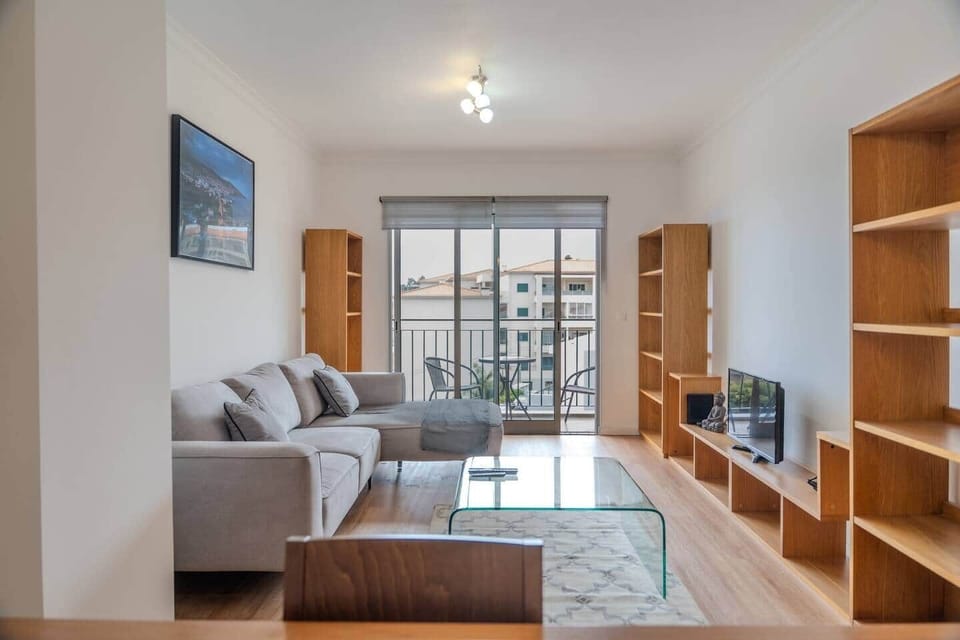 Bright living room opening onto the sea view balcony