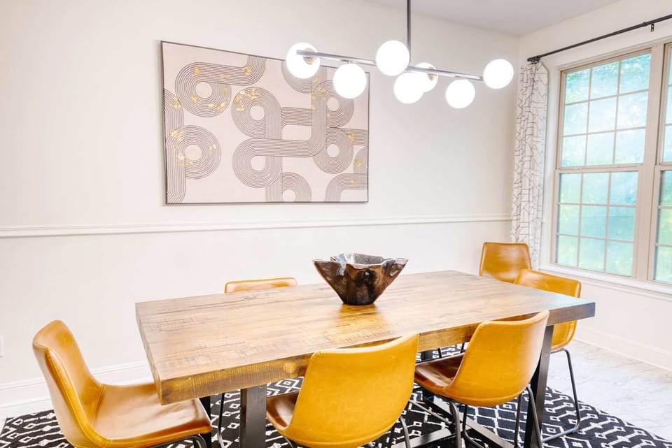🍽️ Stylish dining room under statement lighting seats eight—gather for family meals or board games.