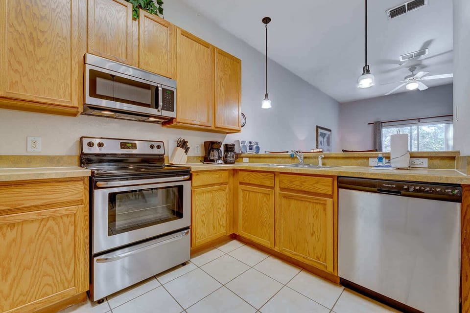 Modern kitchen with stainless steel appliances and oak cabinetry