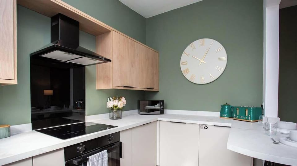 Fully equipped kitchen featuring sleek cabinetry, a cooktop, and all essentials for a comfortable stay