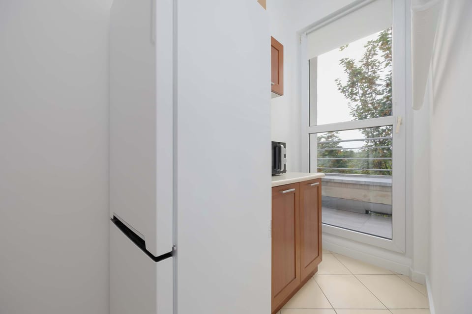 The view of the balcony from the kitchen provides fresh air and natural light while cooking.