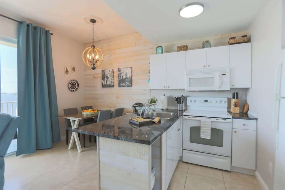 Fully equipped kitchen with stove, oven, microwave, and refrigerator.