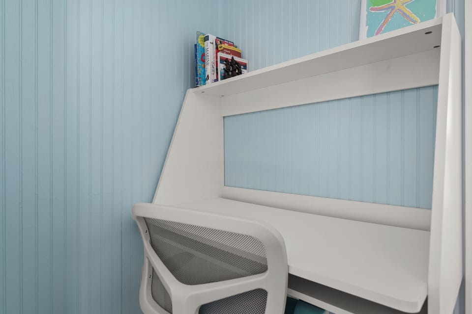 Littleneck Nook with workspace, storage, lamp, and a pack-and-play.
