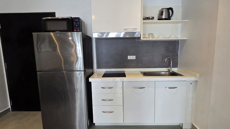 Apartment, Balcony, City View | Private kitchen | Fridge, microwave, stovetop, cookware/dishes/utensils
