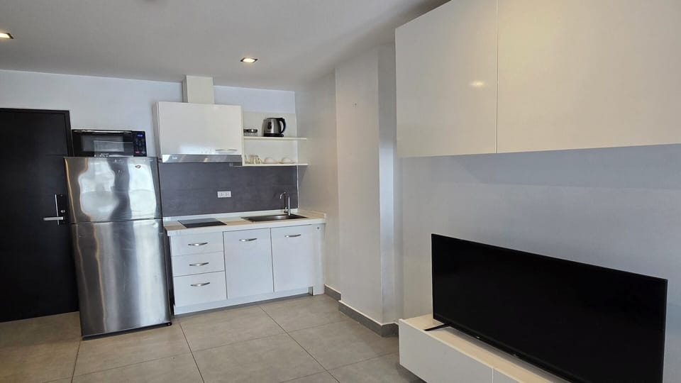 Apartment, Balcony, City View | Private kitchen | Fridge, microwave, stovetop, cookware/dishes/utensils