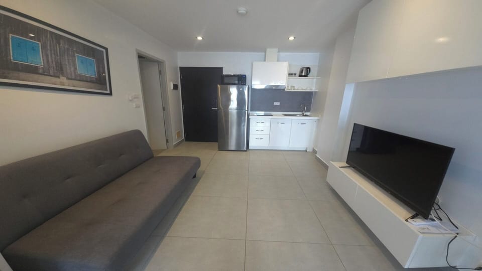 Apartment, Balcony, City View | Living area | Flat-screen TV