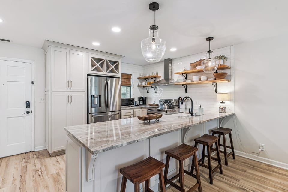 Your spacious kitchen features marble countertops, stainless steel appliances, and a large island where you can gather for meals and conversation.