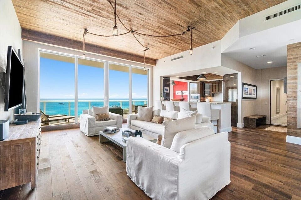 Living Room with 12 ft. ceiling and endless ocean views from the Penthouse