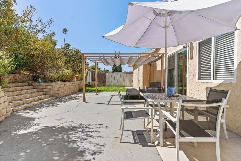 Relax in our sunny backyard patio, featuring a dining area