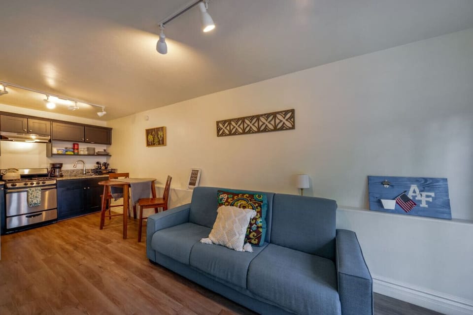 Kitchen and living room with cozy futon and smart TV