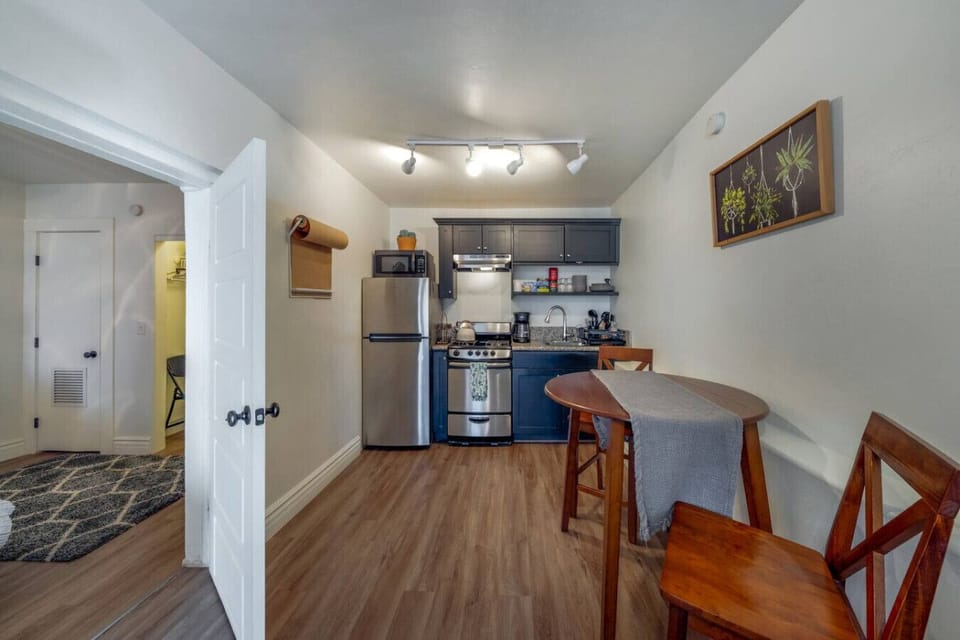 Kitchen area, small but fully equipped with 4-burner gas stove and stainless steel appliances