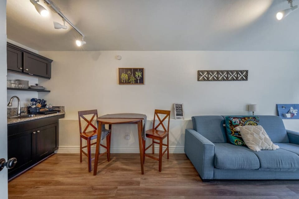 Kitchen, dining area, and living room with futon and smart TV