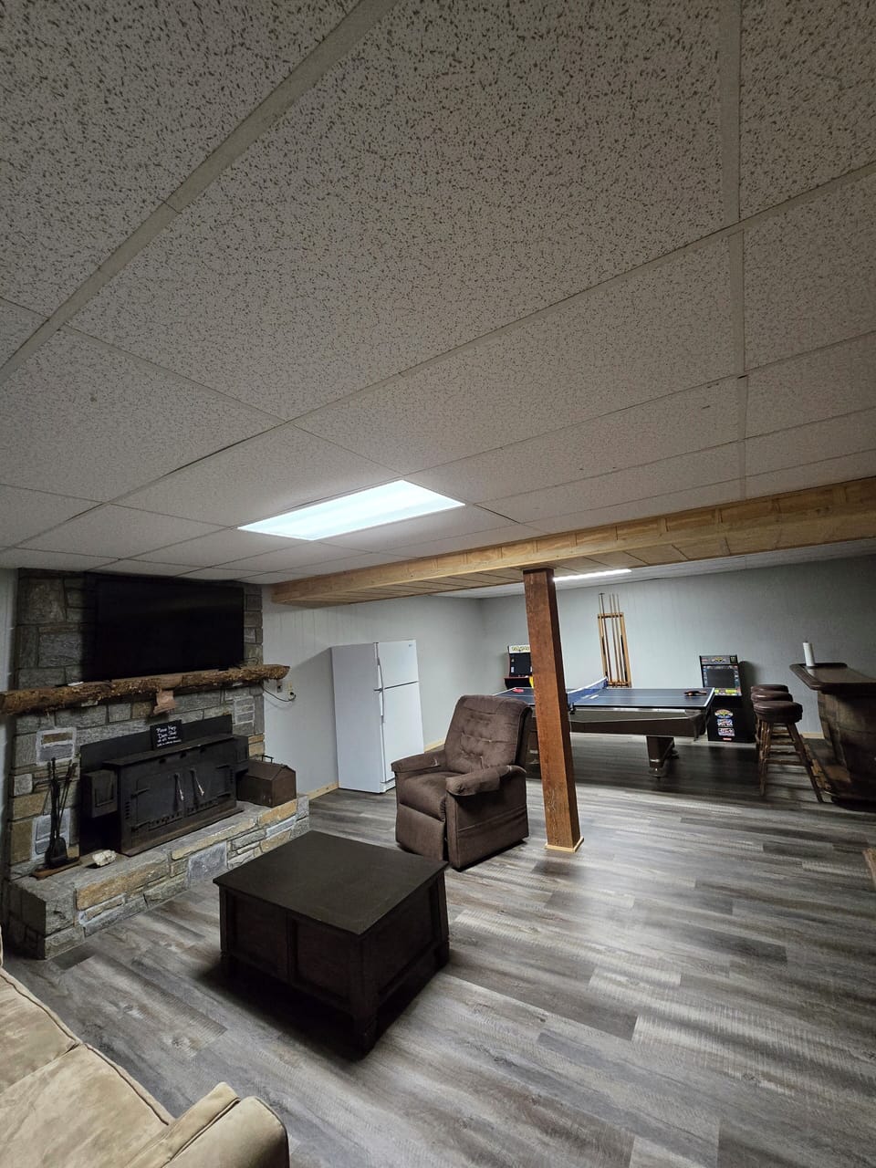 Spacious basement room with bar table 