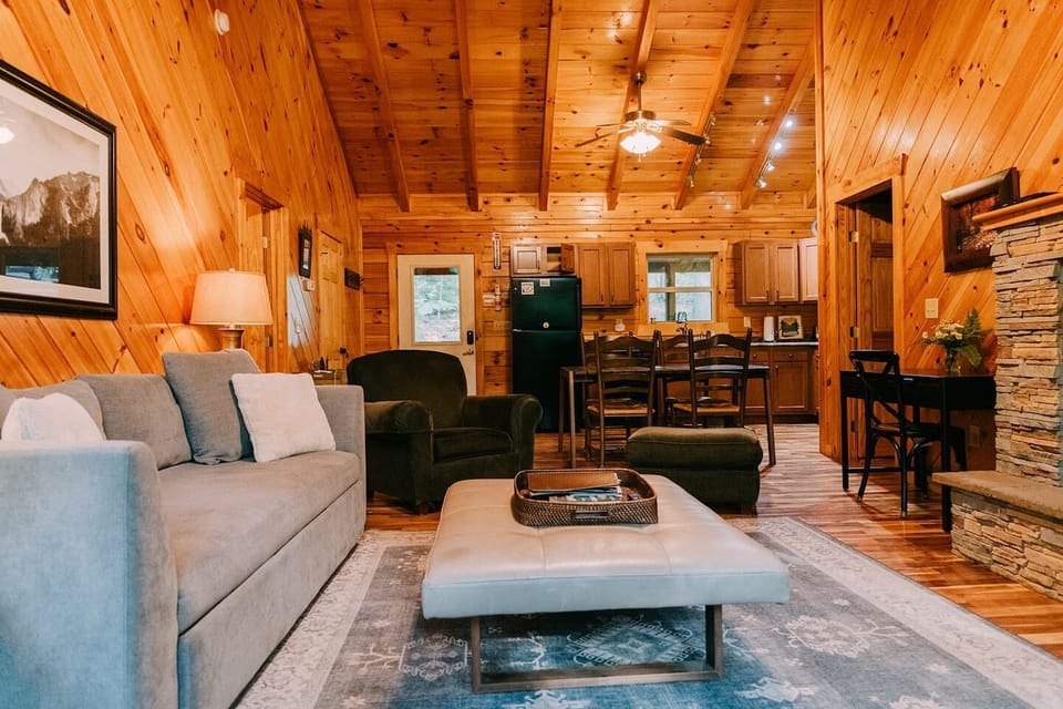 Exceptional cabin interior with vaulted ceilings and classic wood plank walls.