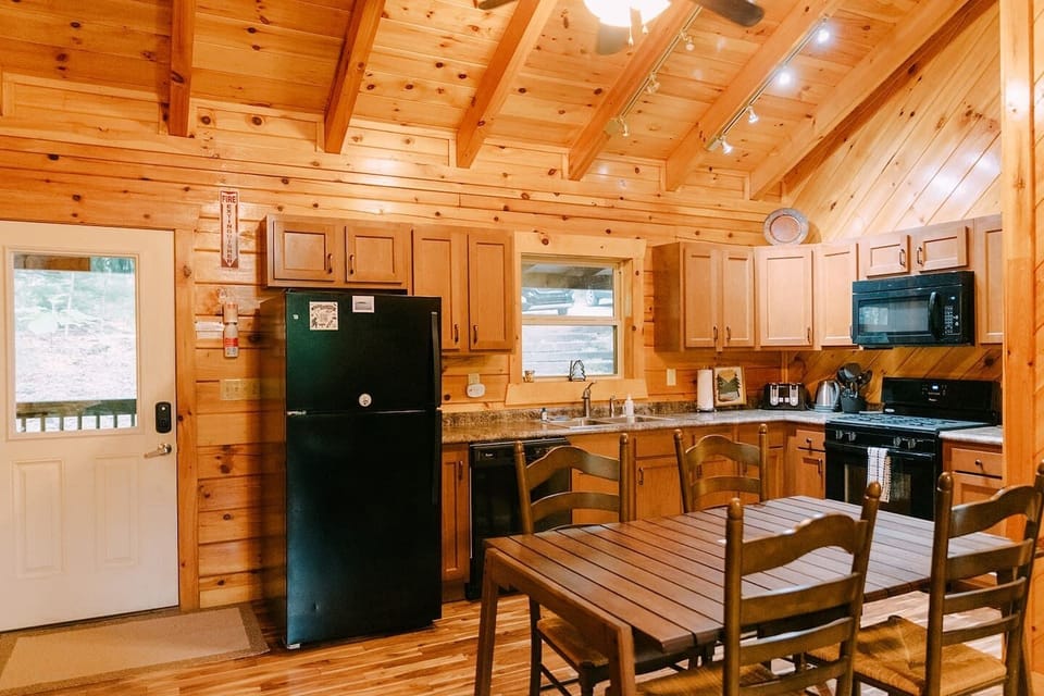 Kitchen has ample dishes, silverware, pots, pans, and other cooking supplies.