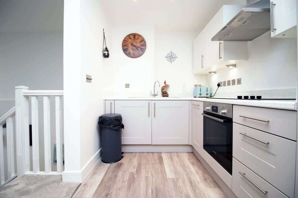 This bright, open kitchen offers generous counter space, modern appliances, and a stylish layout that flows beautifully into the living area, creating a social and functional hub.