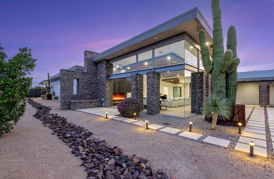 A tranquil desert patio framed by stone and cactus—perfect for morning coffee or stargazing nights.
