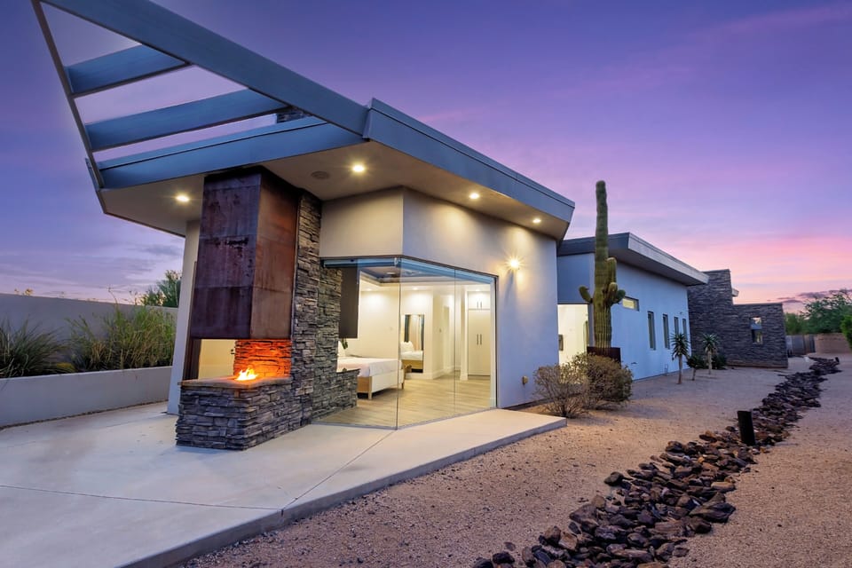 A warm welcome: contemporary design meets cozy charm with a striking outdoor fireplace.