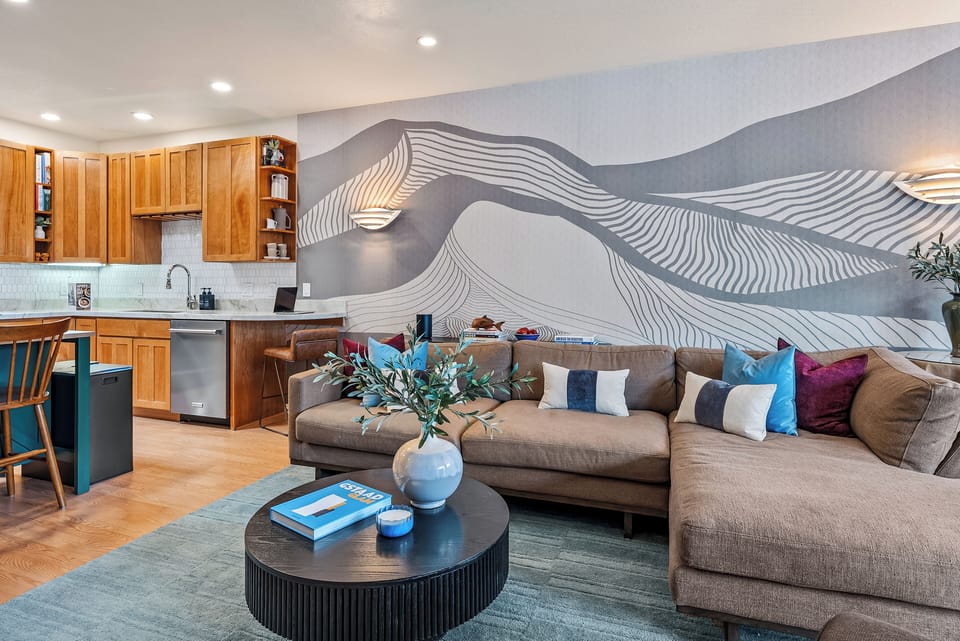 Open concept stocked kitchen > living room w Smart TV > dining room