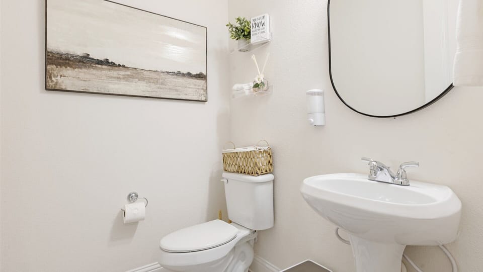 Convenient half bath located on the main level—perfect for guests and quick access without going upstairs.