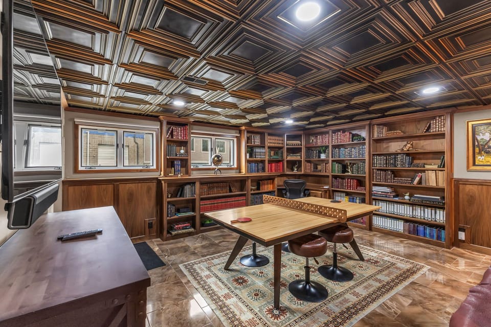 Game room: Lower floor, ping pong table, spacious layout, adjacent to laundry area
