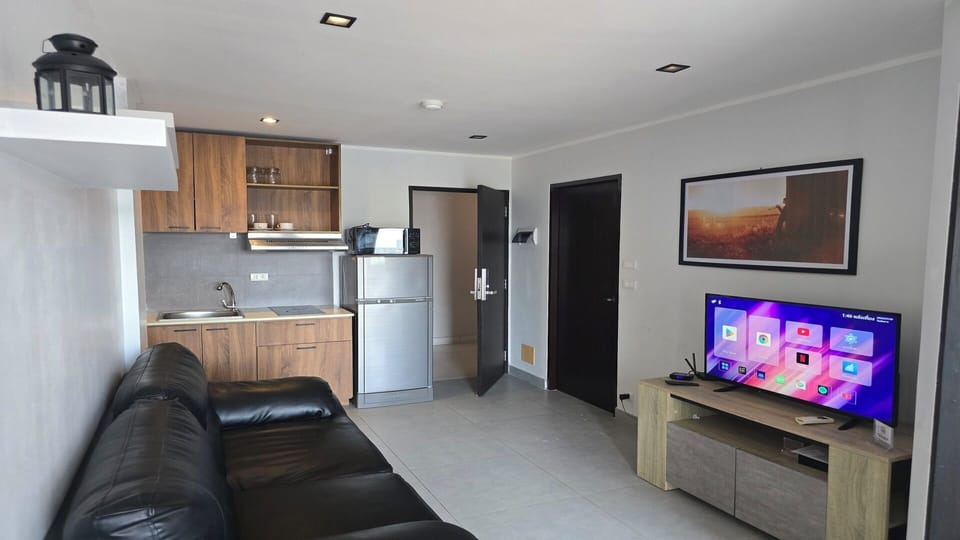 Apartment, Balcony, City View | Living area | Flat-screen TV