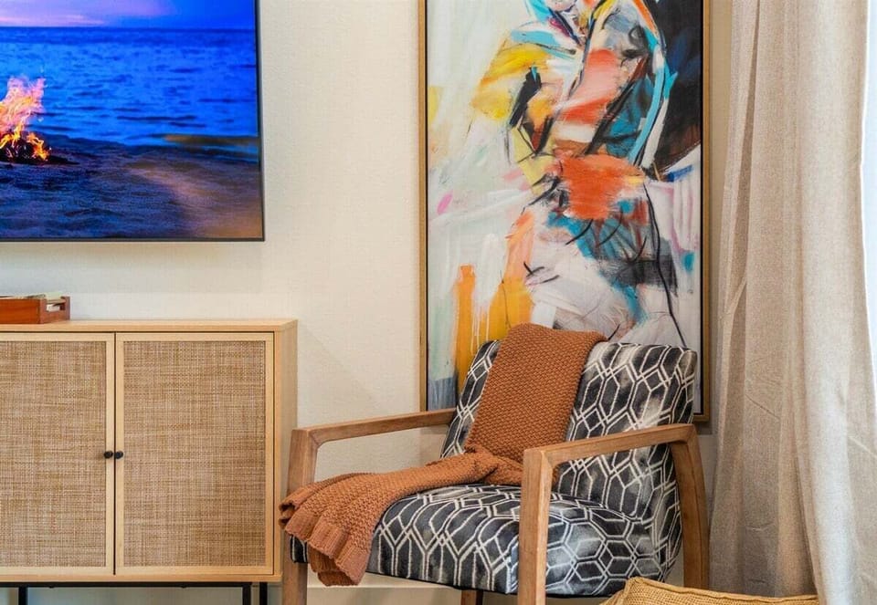 Bright reading nook with colorful artwork and warm lighting.