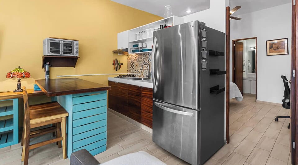 Practical kitchenette with essentials and a breakfast bar.