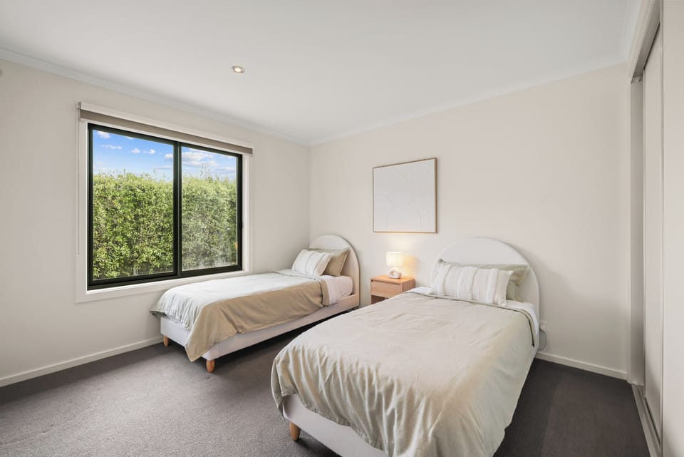 Bright spacious room featuring two comfortable beds