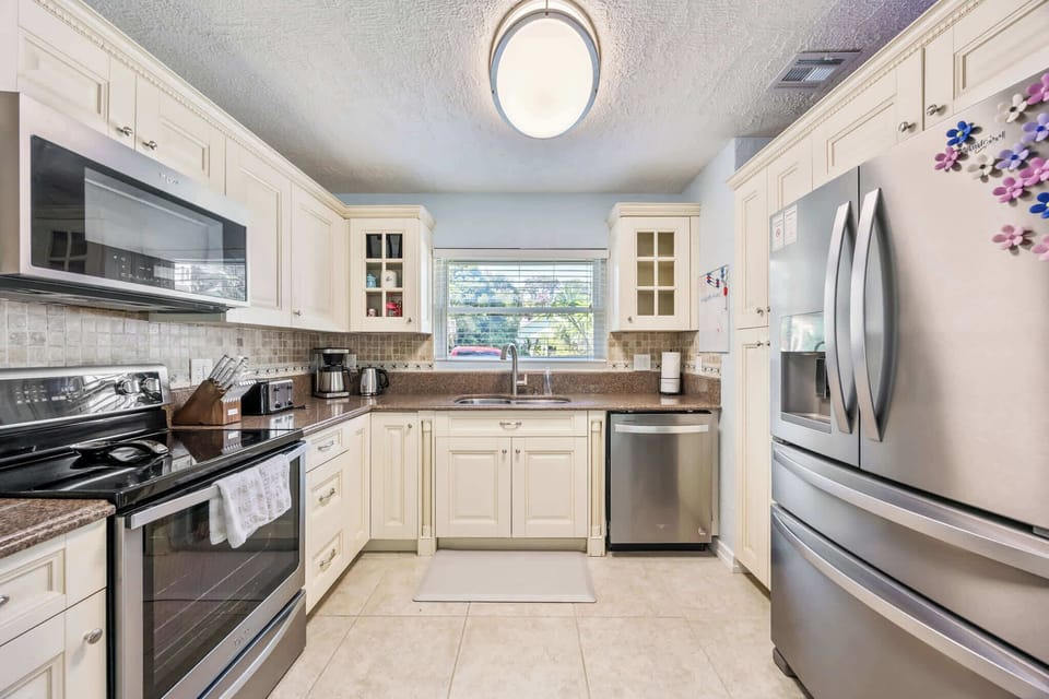 Modern kitchen with stainless steel appliances and cream cabinetry