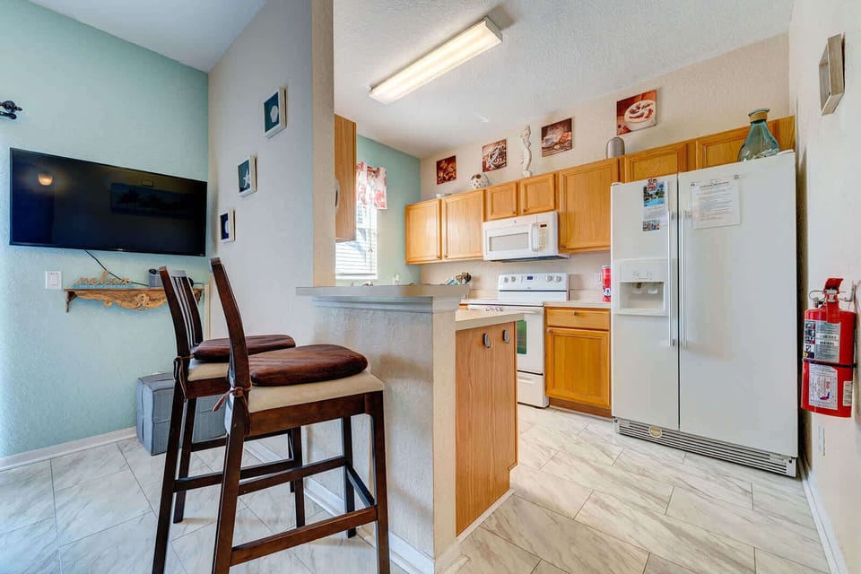 Cozy kitchen with breakfast bar seating and modern appliances.