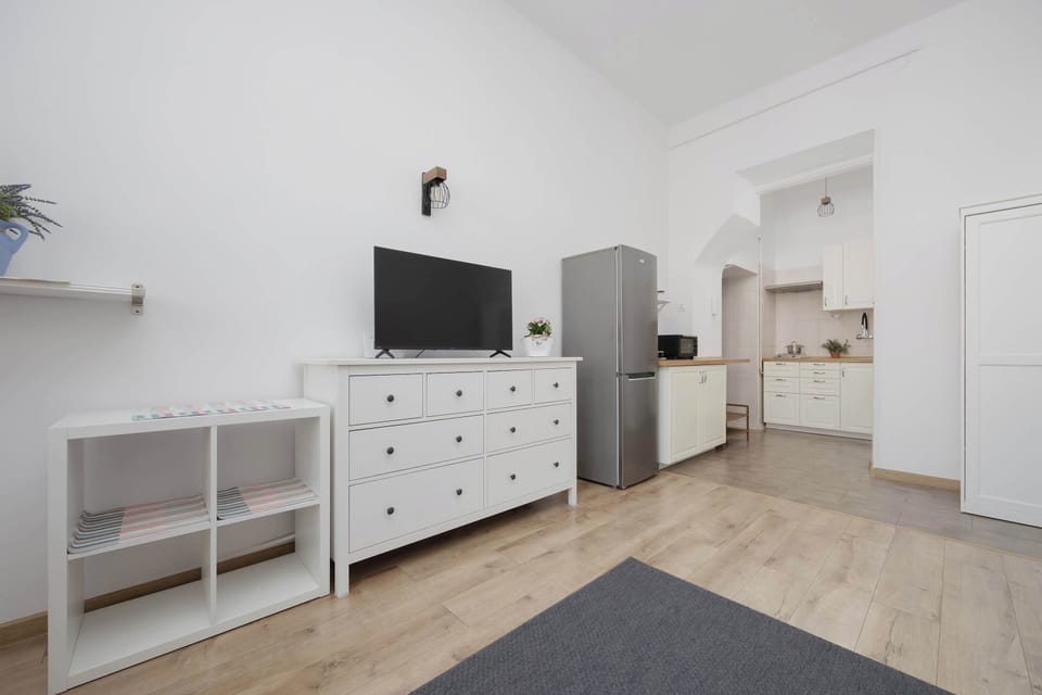 The living room with a TV and spacious dresser combines functionality with style, ensuring everyday comfort.