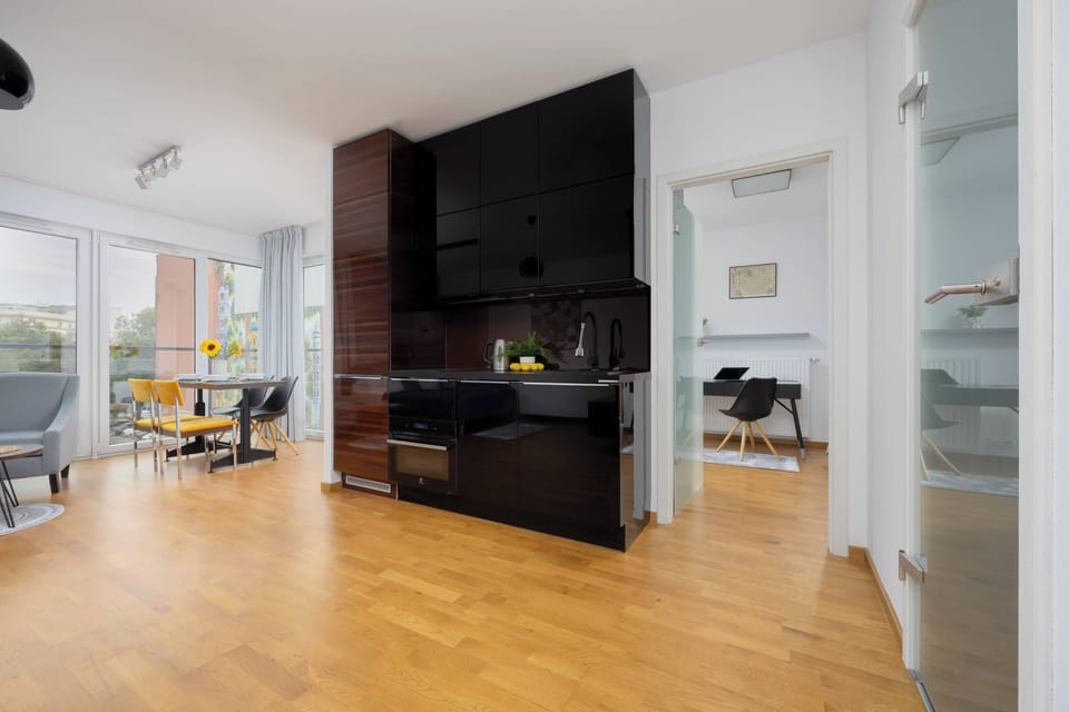 Another view of the kitchenette area with polished dark wood finishes.