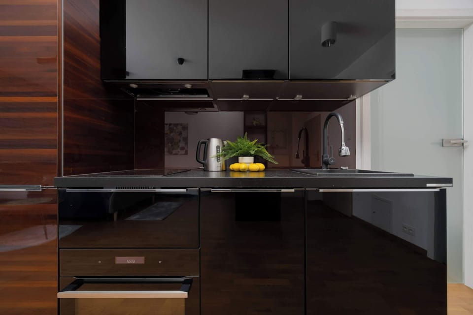 Another view of the kitchenette area with polished dark wood finishes.