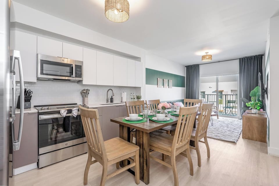 Dine at a stylish table for 6, enjoy balcony views & in-unit laundry.