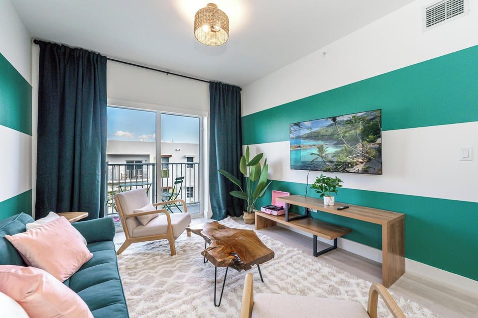 Stylish living room with sofa bed, blackout curtains & balcony access.