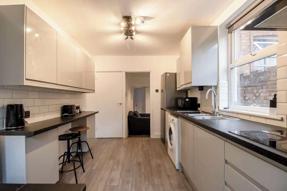 “Full kitchen with a simple dining area — everything you need for home-cooked meals and shared dining moments.”