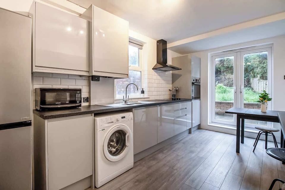 “Full kitchen with a simple dining area — everything you need for home-cooked meals and shared dining moments.”