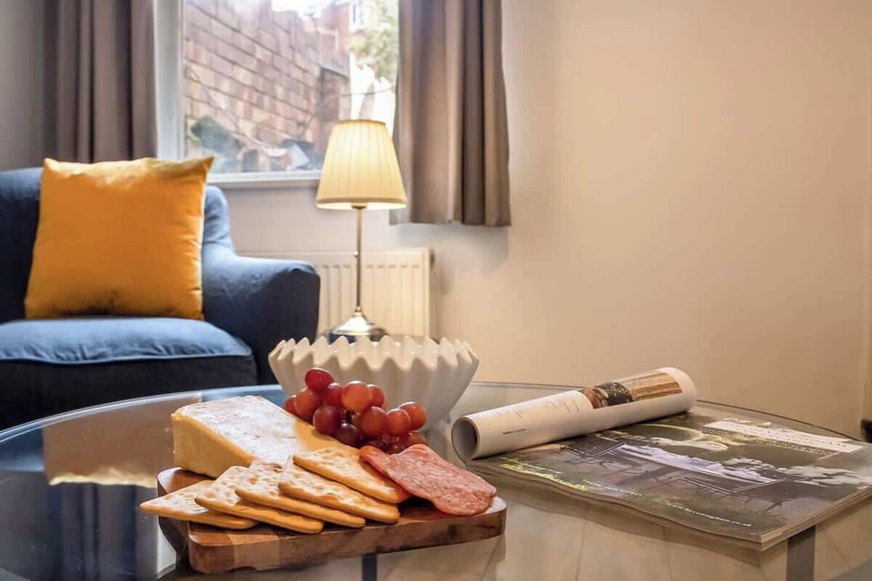 “Simple living room setup with sofas, TV, and a center table — perfect for relaxing and spending time together.”
