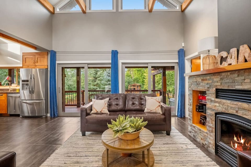 Main level living room with a wood-burning fireplace.